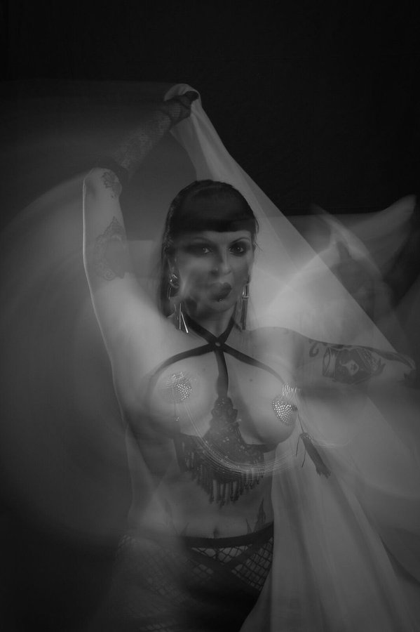 Anaïs Lune behind sheer billowing fabric, black and white