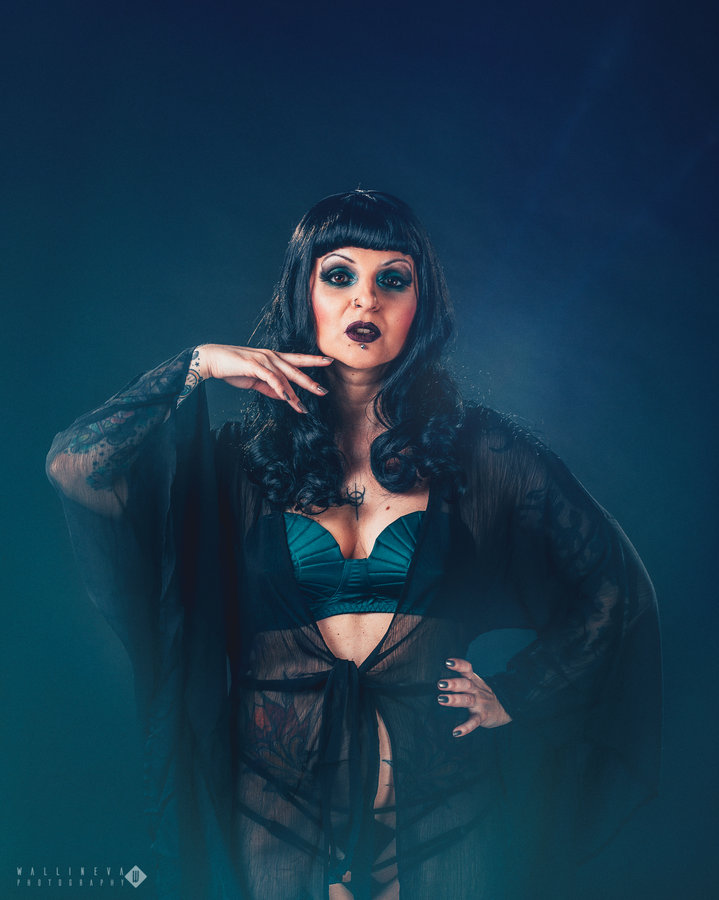 Anaïs Lune in teal lingerie and sheer robe against a teal gradient