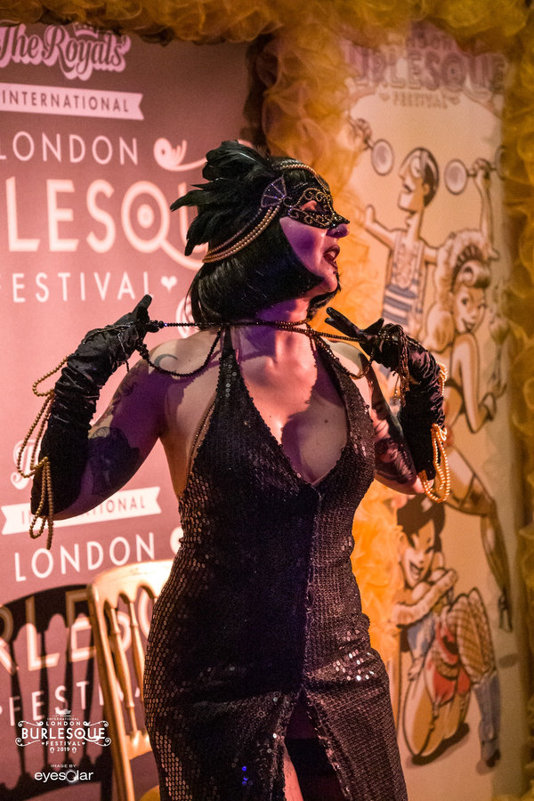 Anaïs Lune in a black sequined bodice and feathered headpiece at London Burlesque Festival